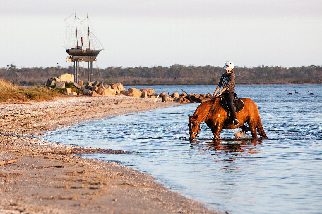 Girl horse-riding in Lake King, Metung, Victoria, Australia
