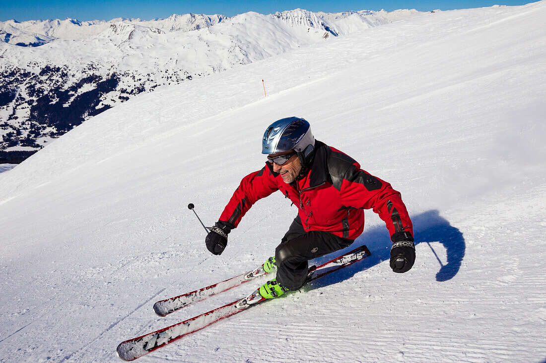 Skier downhill skiing from mount Parpaner Rothorn, Lenzerheide, Canton of Graubuenden, Switzerland