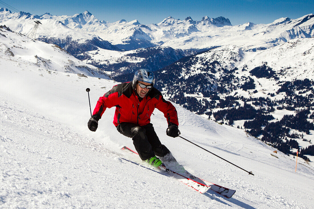 Skier downhill skiing from mount Parpaner Rothorn, Lenzerheide, Canton of Graubuenden, Switzerland
