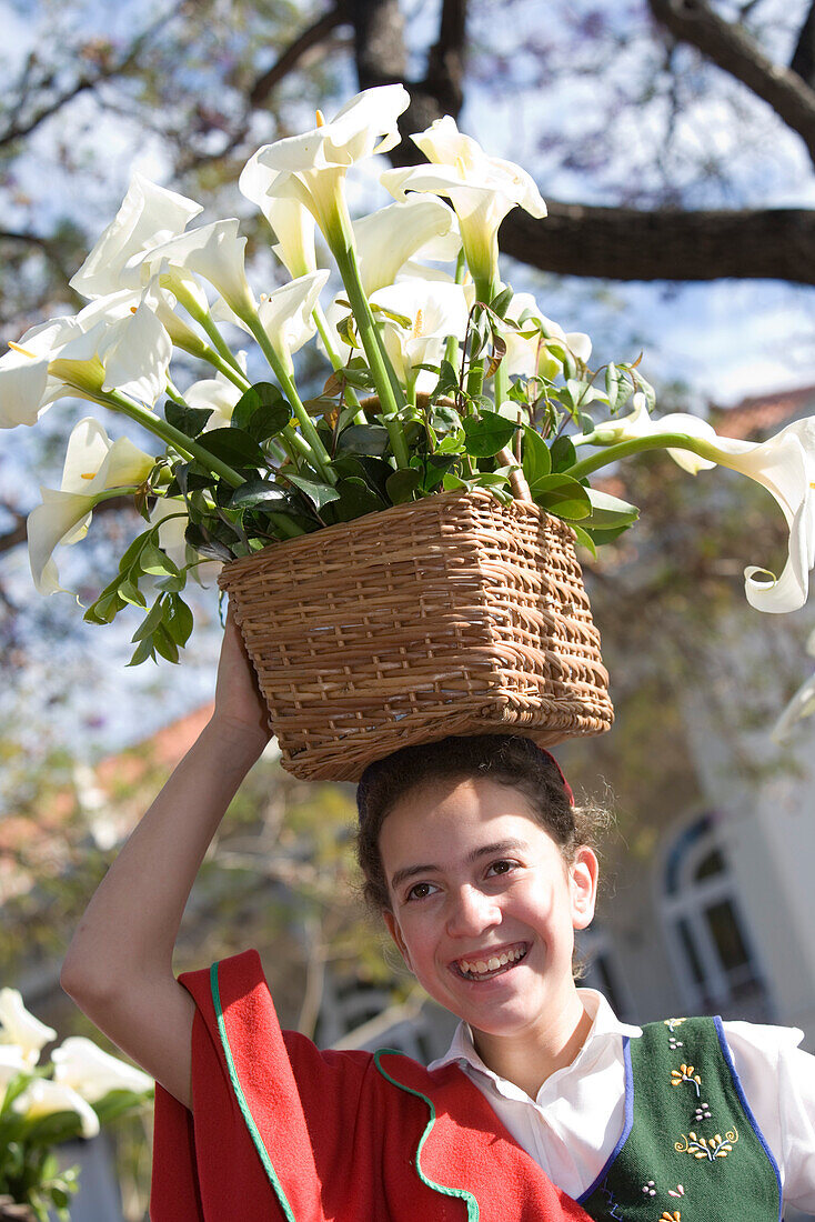 Girl with calla basket on her head at the Madeira Flower Festival Parade, Funchal, Madeira, Portugal