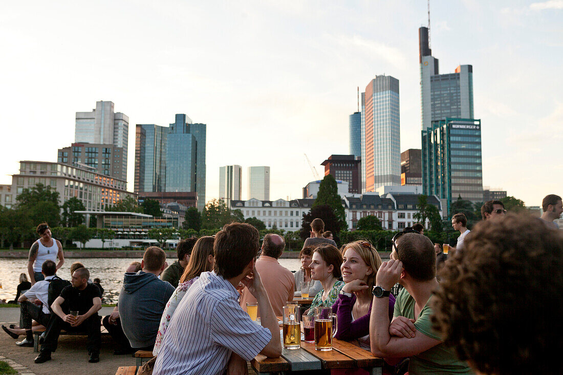 People relaxing in a beer garden on the banks of the Main, Frankfurt, Germany