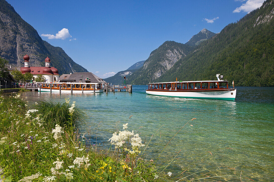 Excursion boat in front of baroque style pilgrimage church St Bartholomae, Koenigssee, Berchtesgaden region, Berchtesgaden National Park, Upper Bavaria, Germany