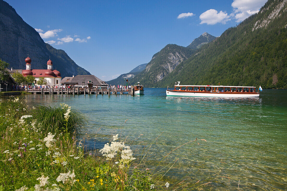 Excursion boat in front of baroque style pilgrimage church St Bartholomae, Koenigssee, Berchtesgaden region, Berchtesgaden National Park, Upper Bavaria, Germany