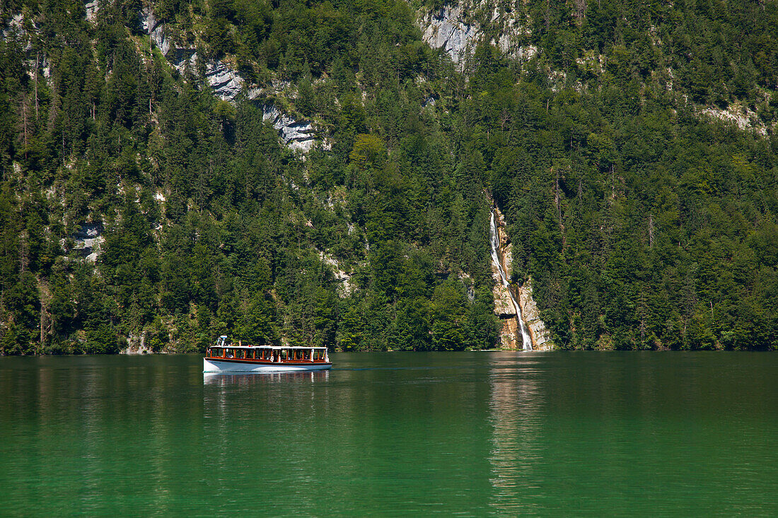 Excursion boat at Schrainbach waterfall, Koenigssee, Berchtesgaden region, Berchtesgaden National Park, Upper Bavaria, Germany