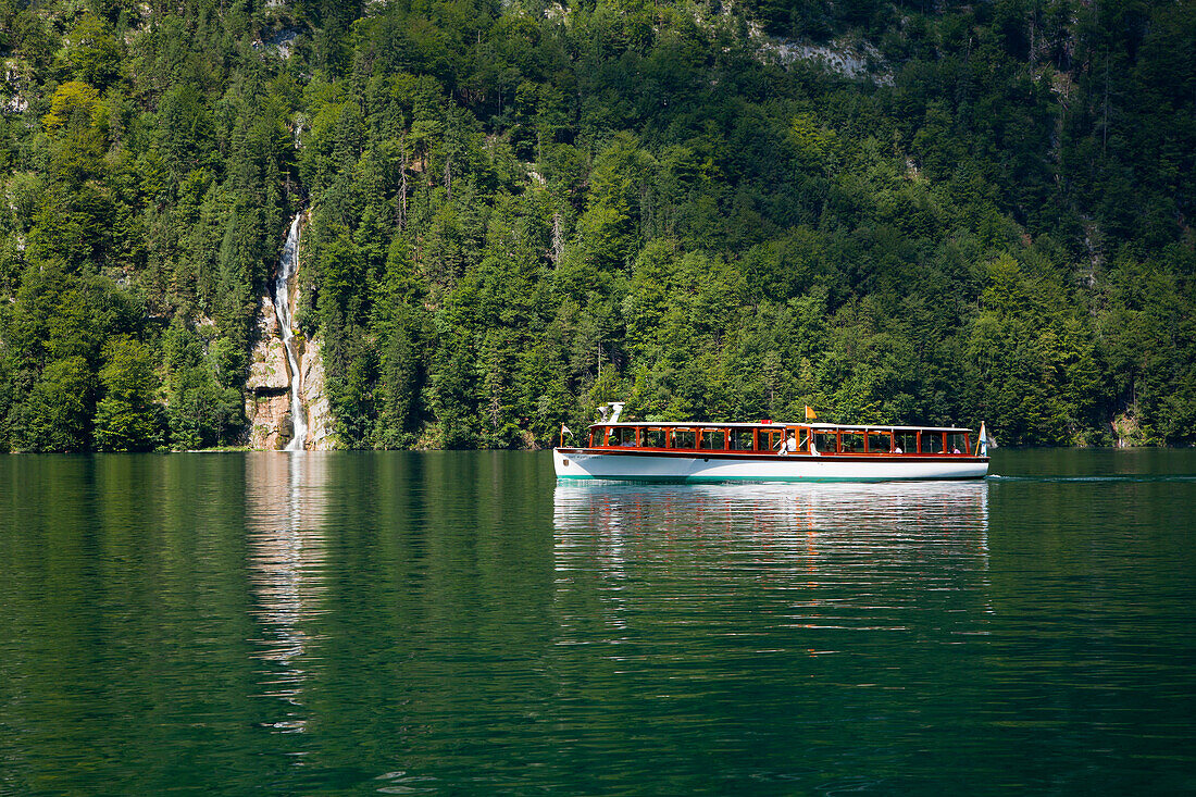 Excursion boat at Schrainbach waterfall, Koenigssee, Berchtesgaden region, Berchtesgaden National Park, Upper Bavaria, Germany