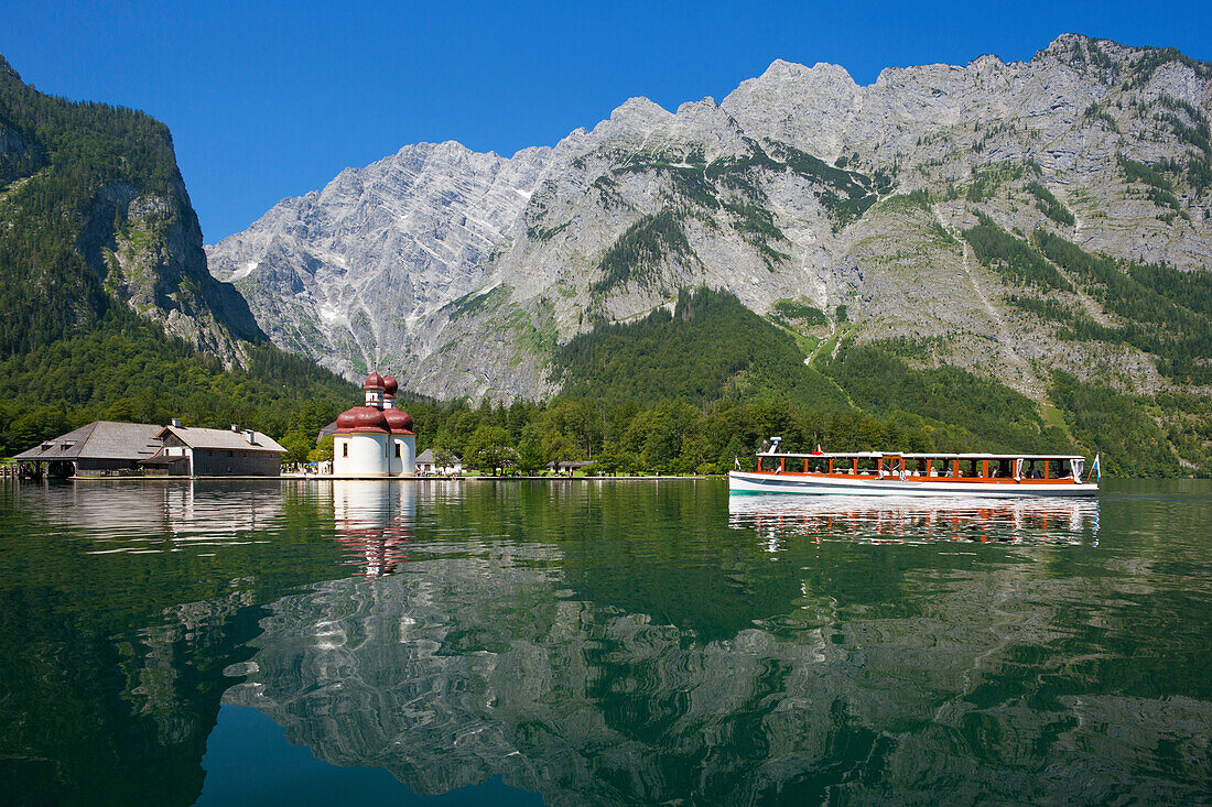 Excursion boat in front of baroque style pilgrimage church St Bartholomae, Watzmann east wall in the background, Koenigssee, Berchtesgaden region, Berchtesgaden National Park, Upper Bavaria, Germany