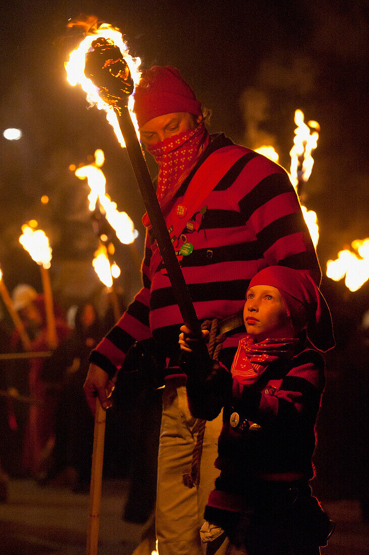 Young Boy Dressed As A Smuggler With Burning Torch On The United Grand Procession, Bonfire Night, Lewes, East Sussex, Uk