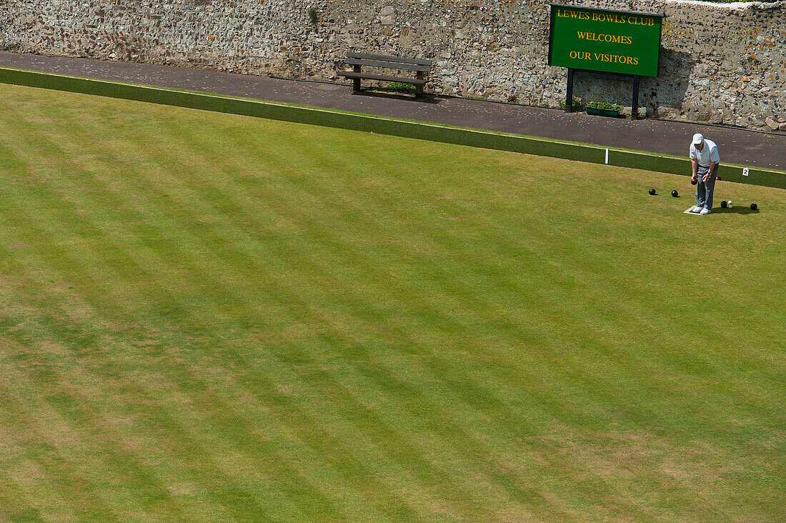 Man Playing Lawn Bowling In Lewes, East Sussex, Uk