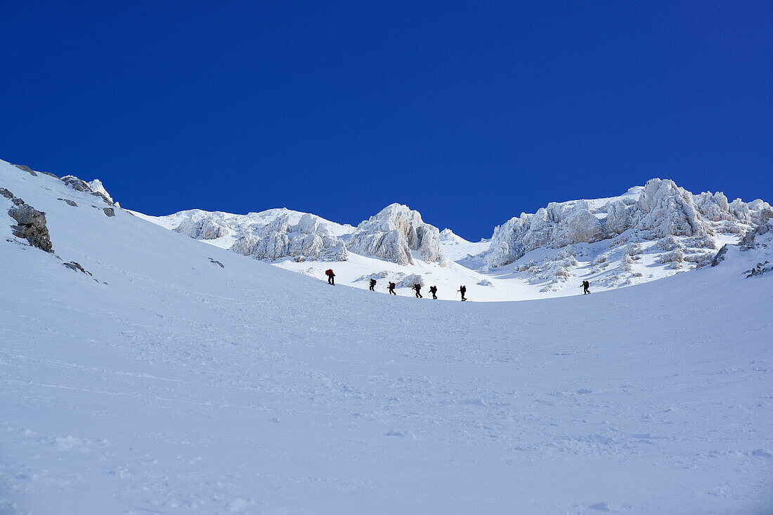 Group of persons back-country skiing ascending Monte Amaro, Rava Giumenta Bianca, Monte Amaro, Majella, Abruzzi, Apennines, l' Aquila, Italy