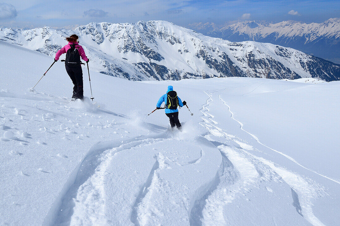 Two female backcountry skier downhill skiing, Malgrubler, Tux Alps, Tyrol, Austria