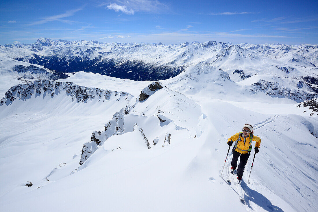 Female backcountry skier ascending to Vallatscha, Ortler in background, Ofenpass, Grisons, Switzerland