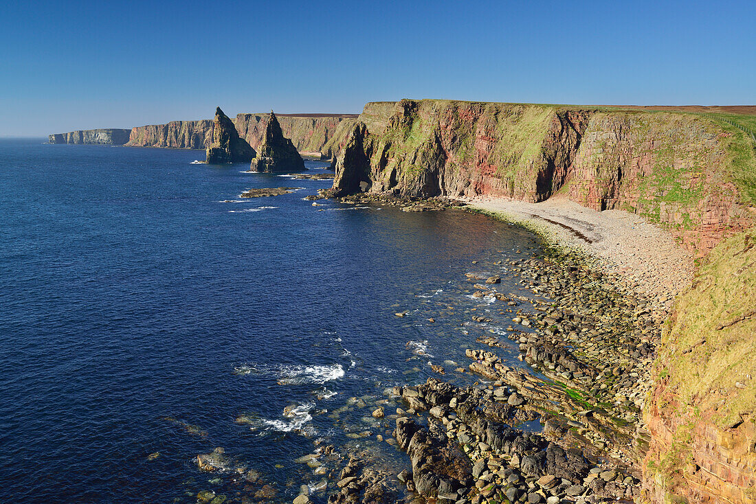 Rock pinnacles standing in the sea, Duncansby Stacks, coast of Duncansby, Duncansby, Scotland, Great Britain, United Kingdom
