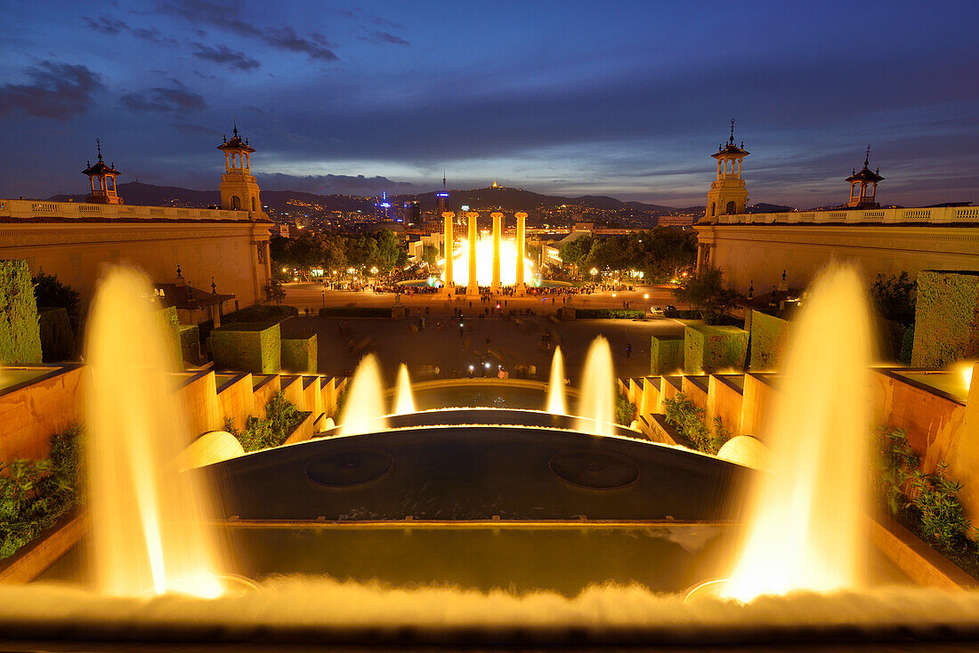 Illuminated fountain Font Magica with view to Barcelona at night, Palau Nacional, National Museum, Montjuic, Barcelona, Catalonia, Spain