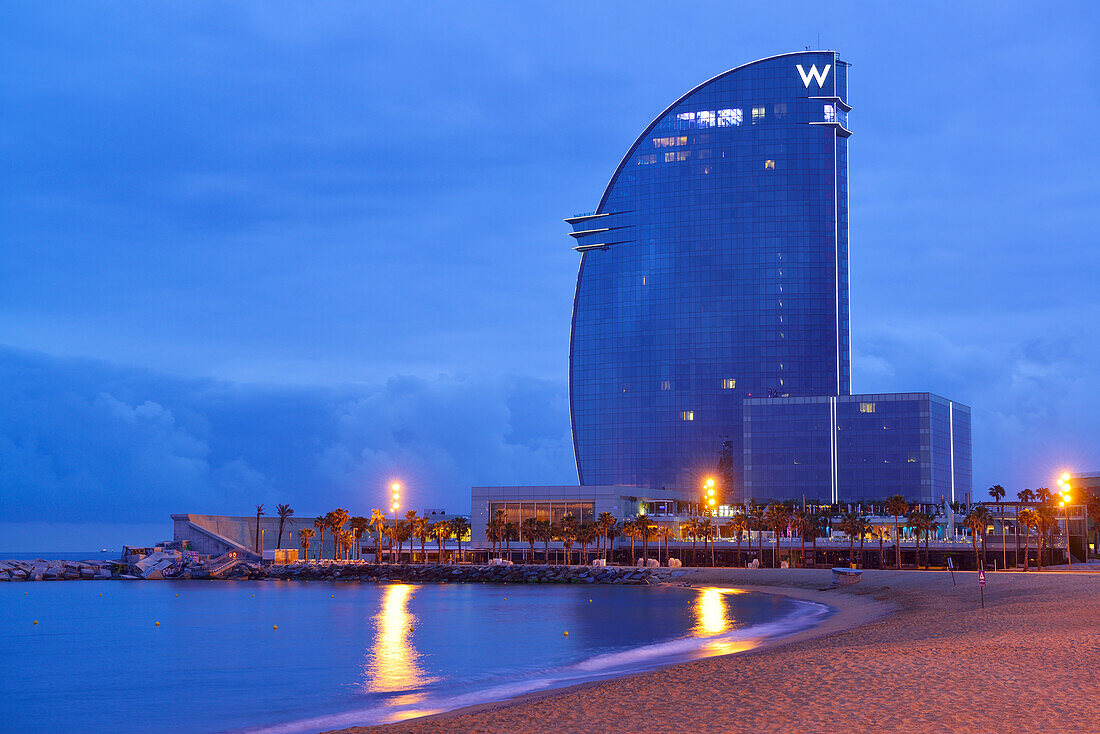Hotel W and beach, illuminated at night, architect Ricardo Bofill, Barceloneta, Barcelona, Catalonia, Spain