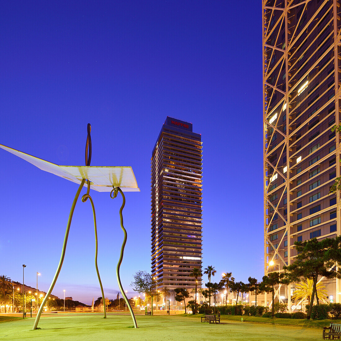 Modern sculpture in front of twin towers Hotel Arts and Mapfre Tower, illuminated, Olympic village, Barceloneta, Barcelona, Catalonia, Spain
