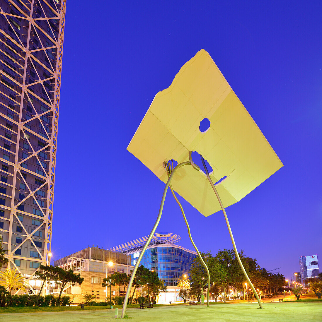 Modern sculpture in front of twin towers Hotel Arts and Mapfre Tower, illuminated at night, Olympic village, Barceloneta, Barcelona, Catalonia, Spain