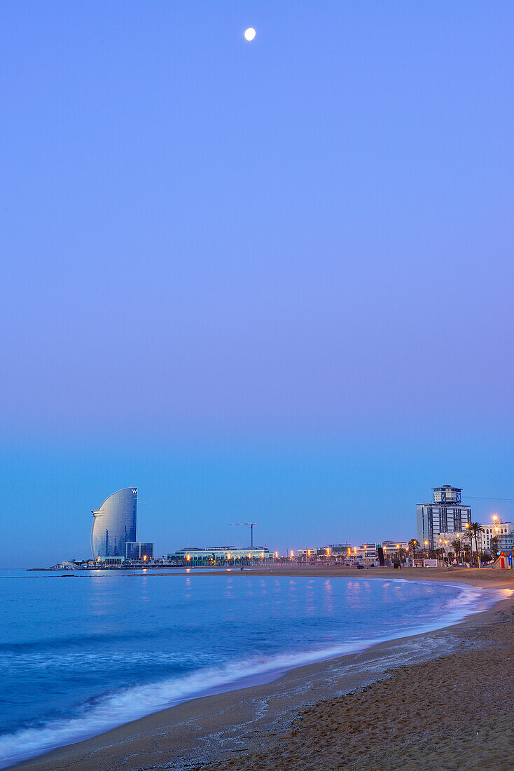Hotel W and beach, illuminated at night, architect Ricardo Bofill, Barceloneta, Barcelona, Catalonia, Spain