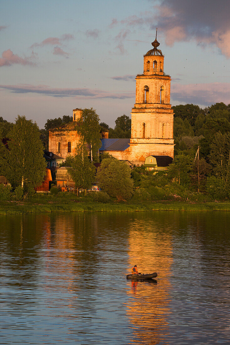 Fishing boat and church tower along the ´river, near Yaroslavl, Russia, Europe