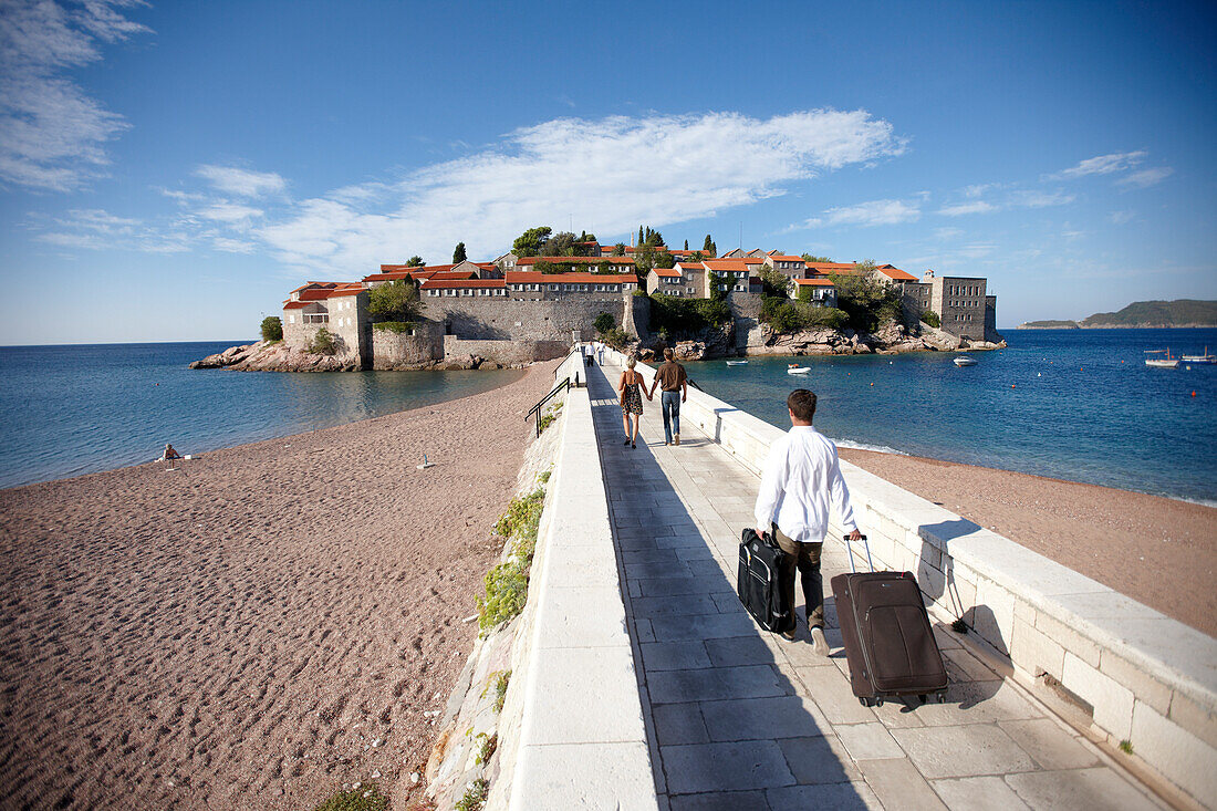 Guests passing isthmus to Aman Sveti Stefan, Sveti Stefan, Budva, Montenegro