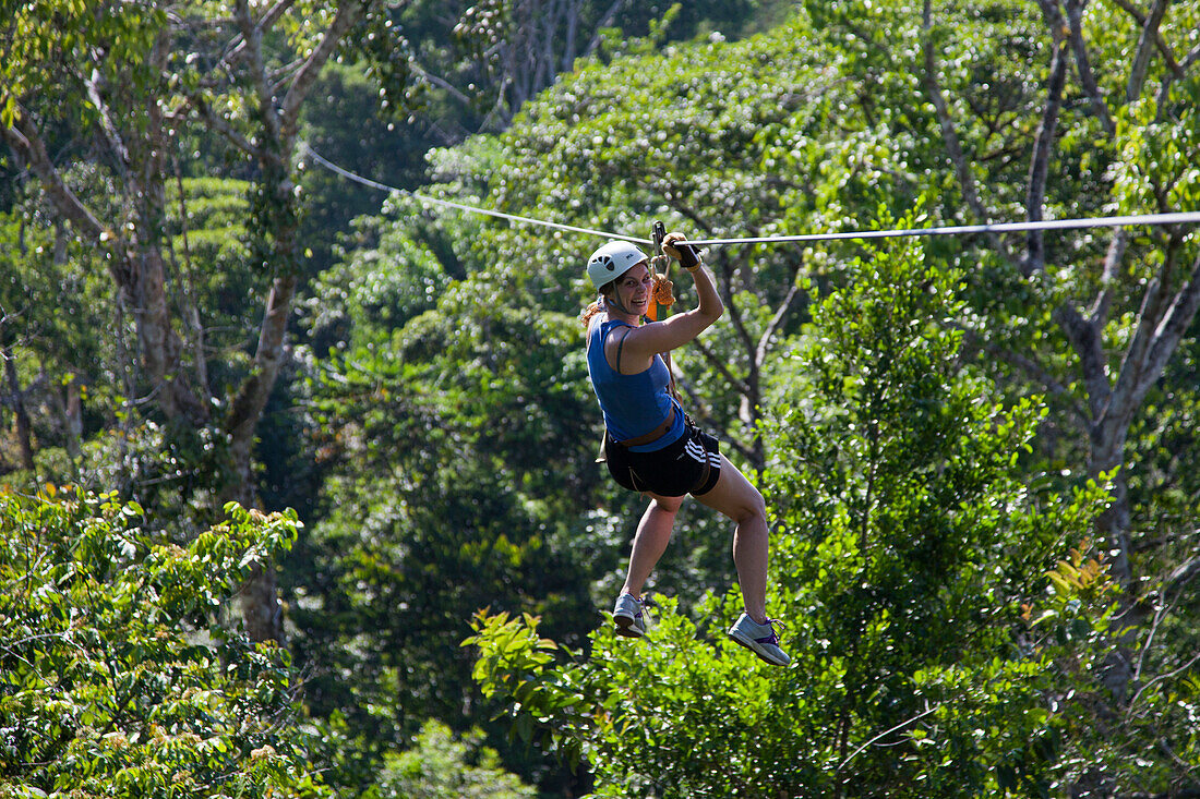 Celebrity chef Sarah Wiener ziplining through a rainforest canopy, Golfito, Puntarenas, Costa Rica