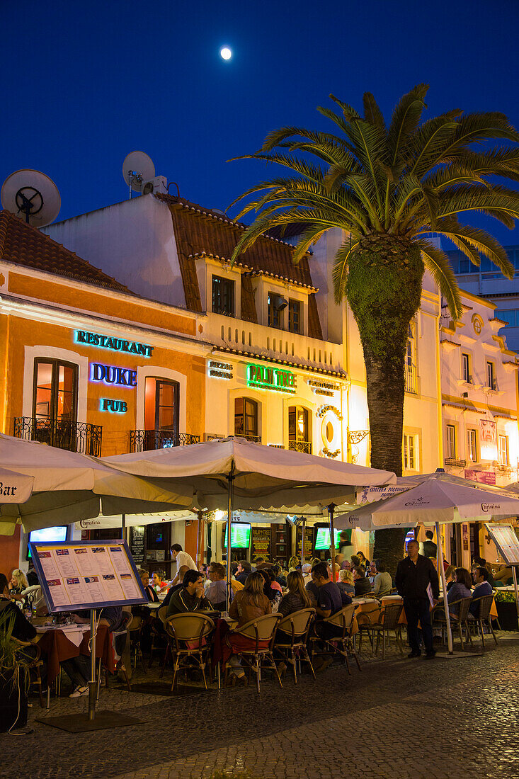 Restaurants with outdoor seating on Praca Costa Pinto square at dusk, Cascais, near Lisbon, Lisboa, Portugal