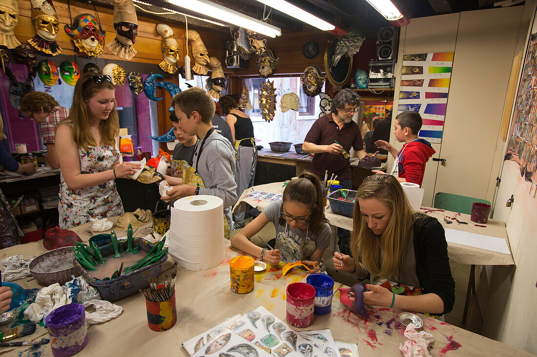 Children painting self-made masks ni Ca' Macana carnival mask workshop, Venice, Veneto, Italy, Europe