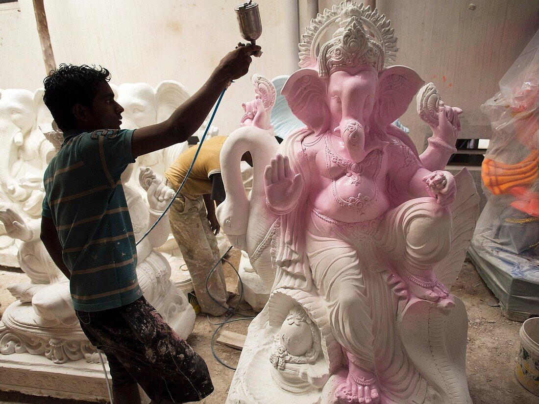 Painting Ganesha statues for the Ganesha Chaturthi festivities in Bangalore, India