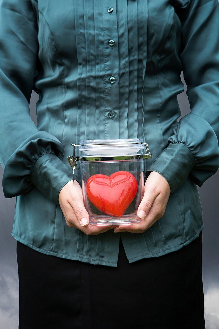 Woman holding a jar with a heart