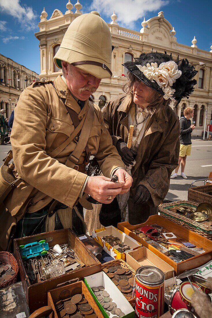 Kilted soldier and lady in Victorian dress browse for brass buttons, Victorian festival, historic precinct, Oamaru, Otago