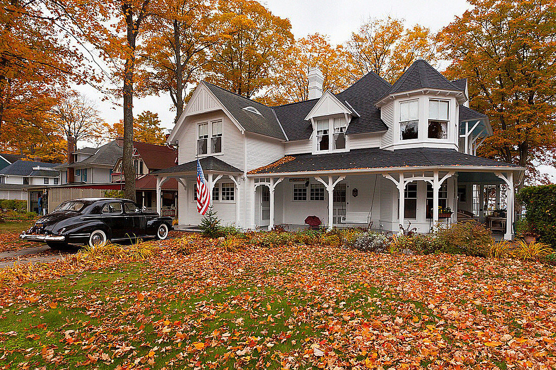 A Colonial home with fall foliage color in Petoskey, Michigan, USA