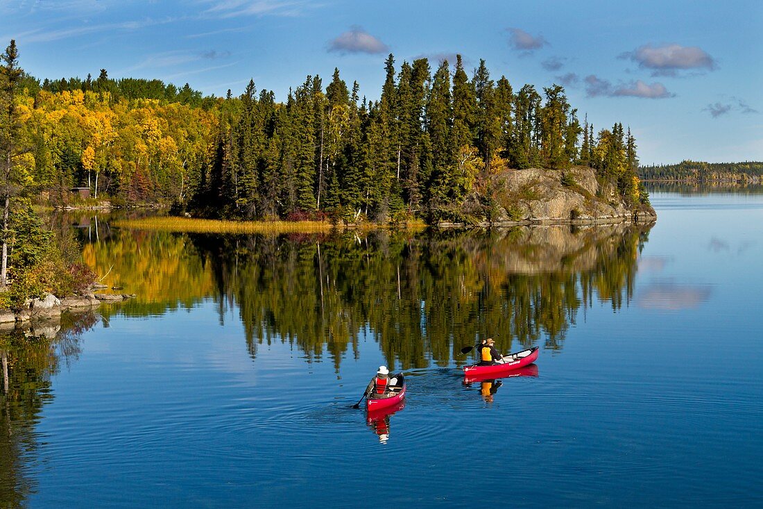 A northern Manitoba landscape of fall foliage color and reflections in a small lake at Baker Narrows near Flin Flon, Manitoba, Canada