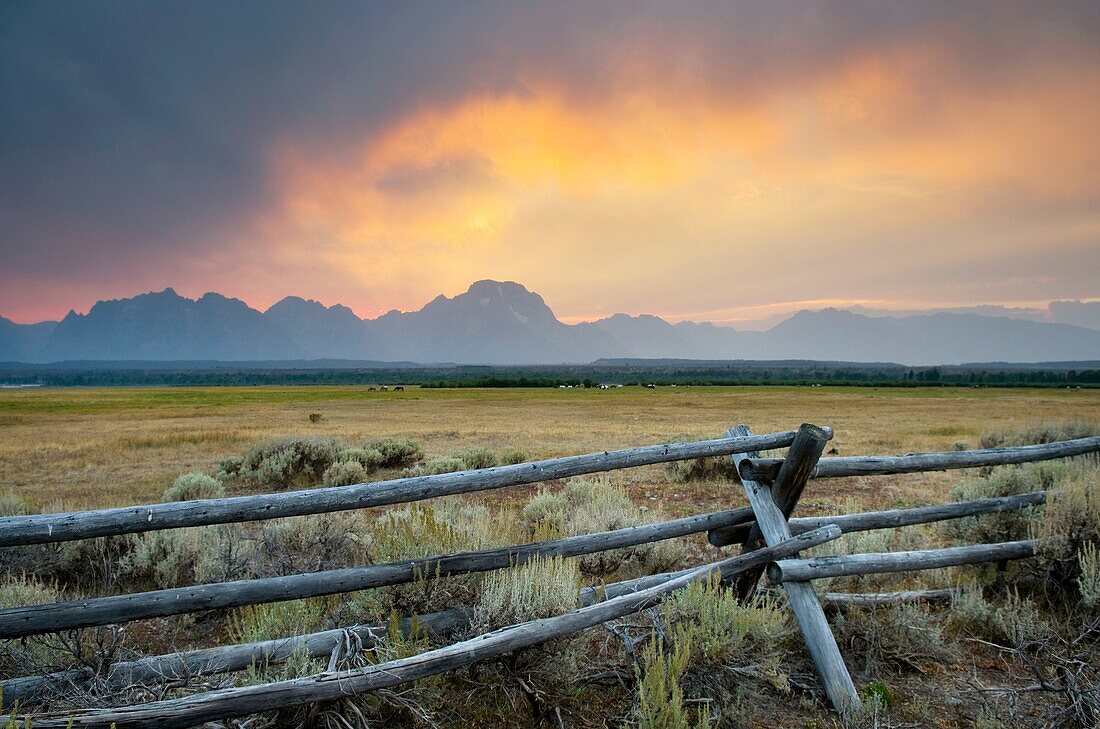 Sunset through storm clouds over the Teton Range, Grand Teton National Park, Wyoming