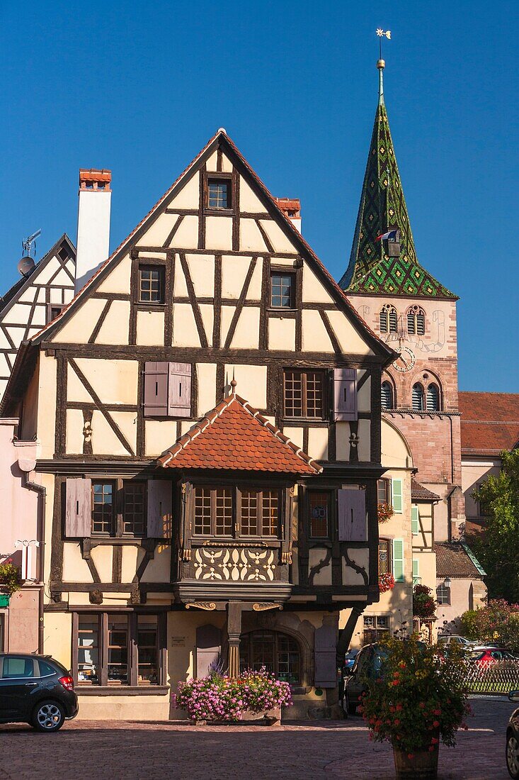 Traditional timbered house and church Sainte Anne in Turckheim, Alsace, France, Europe