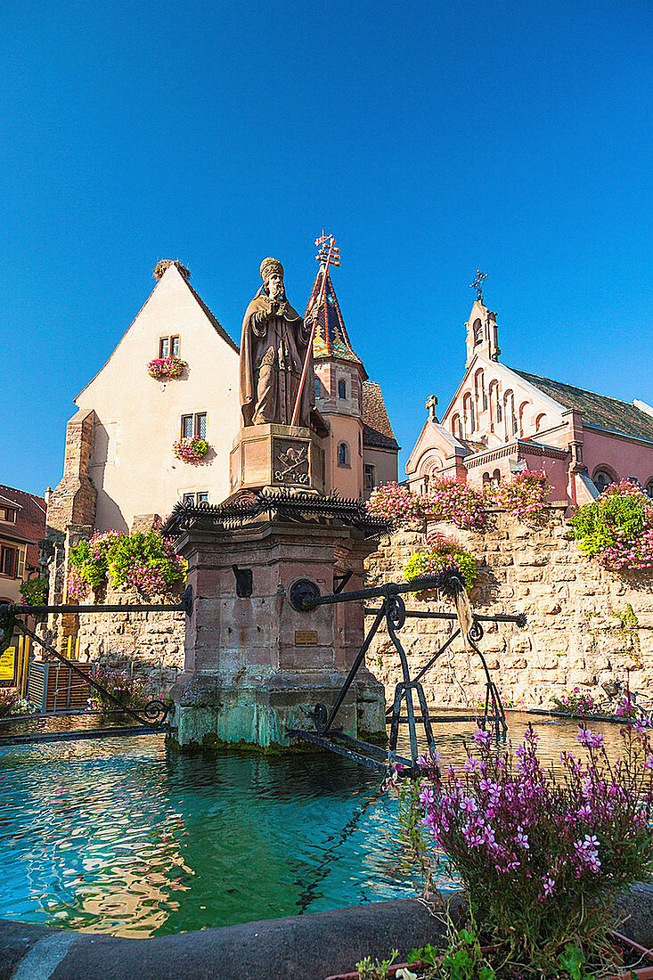 Saint-Leon fountain in the picturesque village of Eguisheim, Alsace, France, Europe