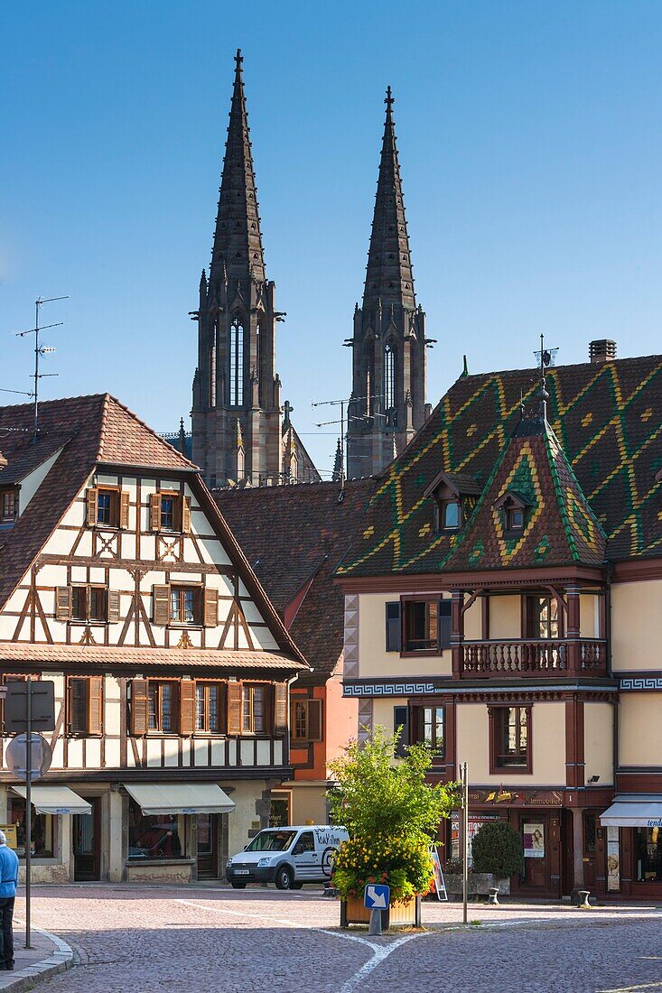 Timbered houses with the church Saint Pierre and Saint Paul in the background, Obernai, Alsace, France