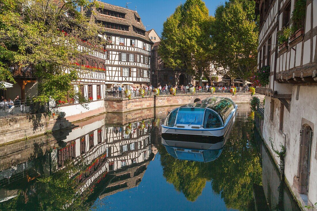 Timbered houses and a sightseeing boat on a canal in the quarter Petite France, Strasbourg, Alsace, France, Europe