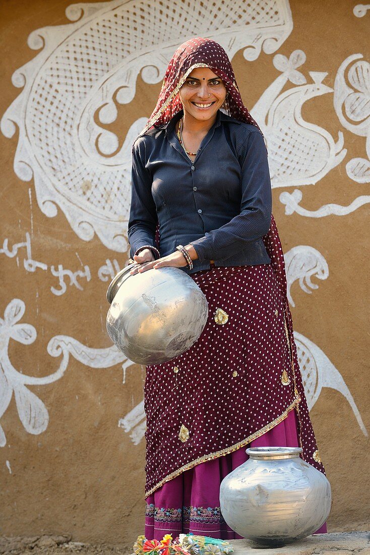 India, Rajasthan, Tonk region, Cheerful woman at the village well.