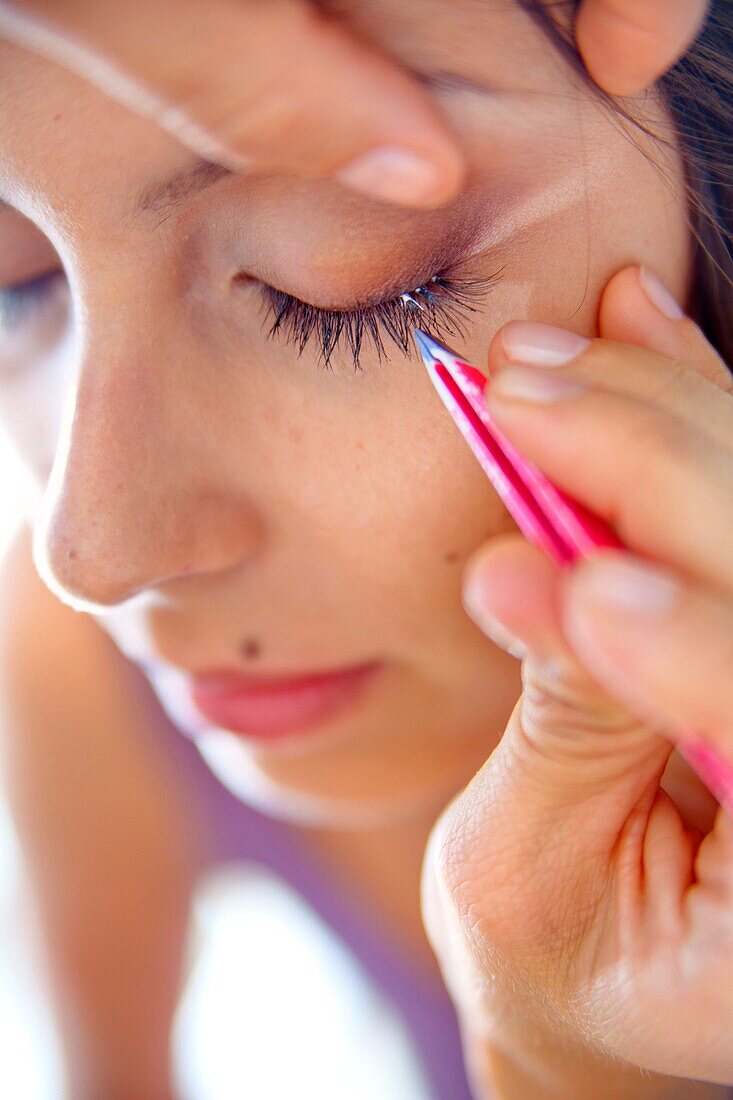 Woman during eye lashes extensions