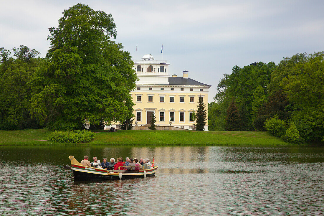 Boat trip on the lake in front of Woerlitz castle, Woerlitz, UNESCO world heritage Garden Kingdom of Dessau-Woerlitz, Saxony-Anhalt, Germany