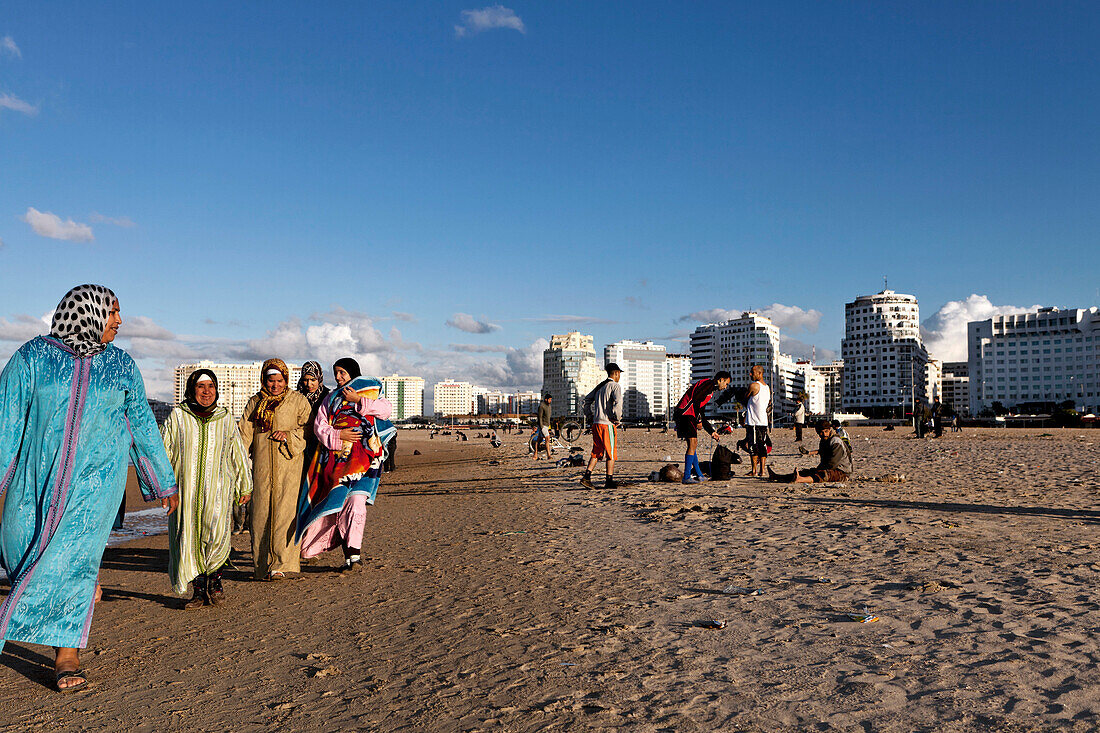 Moroccan women walking along the shore, Tangiers, Morocco