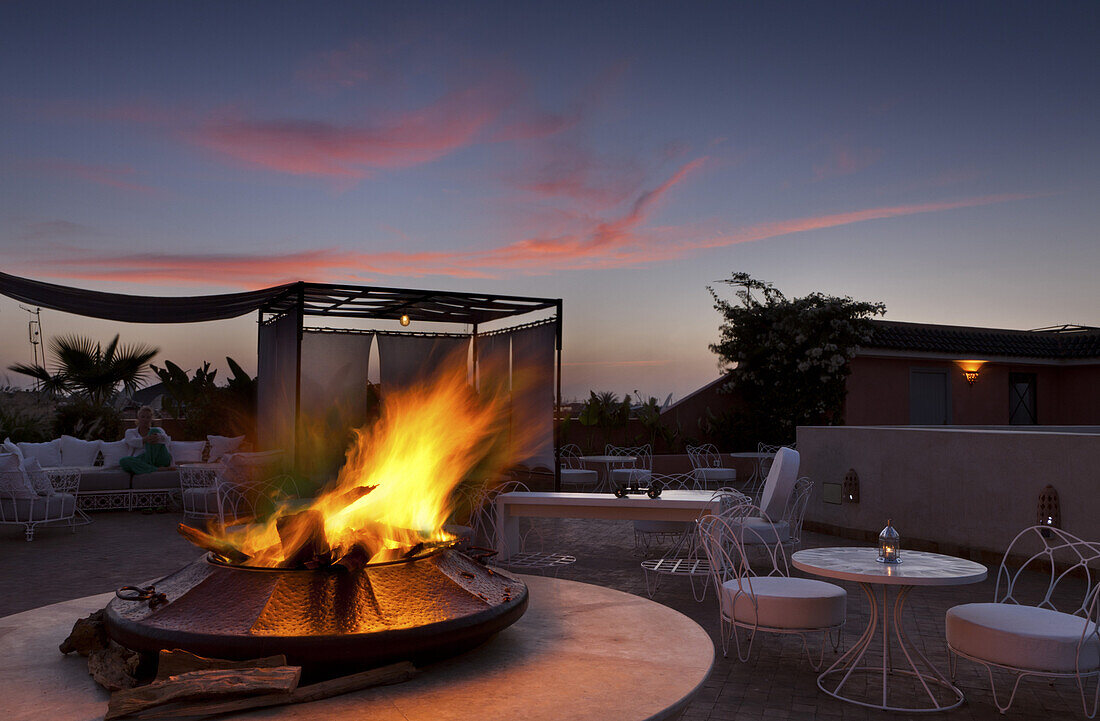 Rooftop terrace with fireplace, Riad Nashira, Marrakech, Morocco