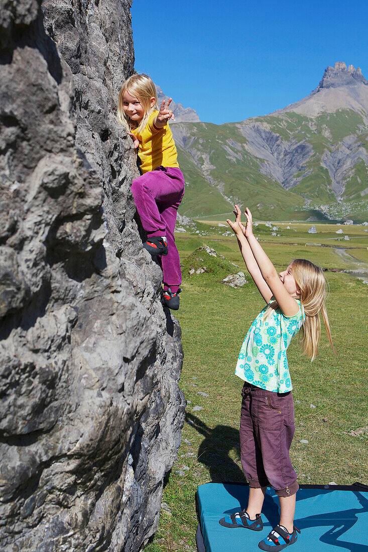Two girls bouldering, climbing, Engstligenalp, Bernese Oberland, Switzerland