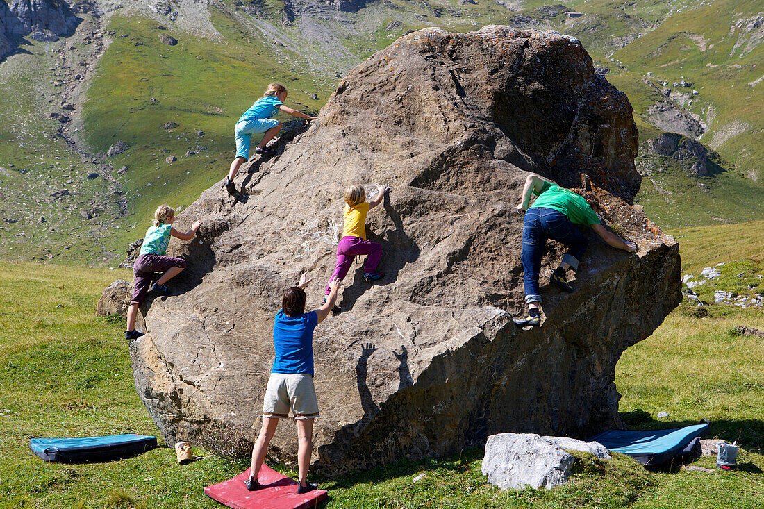 Children and adults bouldering, climbing, Engstligenalp, Bernese Oberland, Switzerland