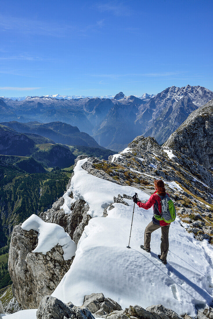 Woman ascending to Hohes Brett, Hundstod and Watzmann massif in background, Hoher Goell, Berchtesgaden National Park, Berchtesgaden Alps, Upper Bavaria, Bavaria, Germany