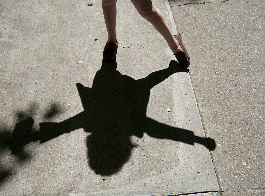Dancing Girl's Shadow on Cement Sidewalk