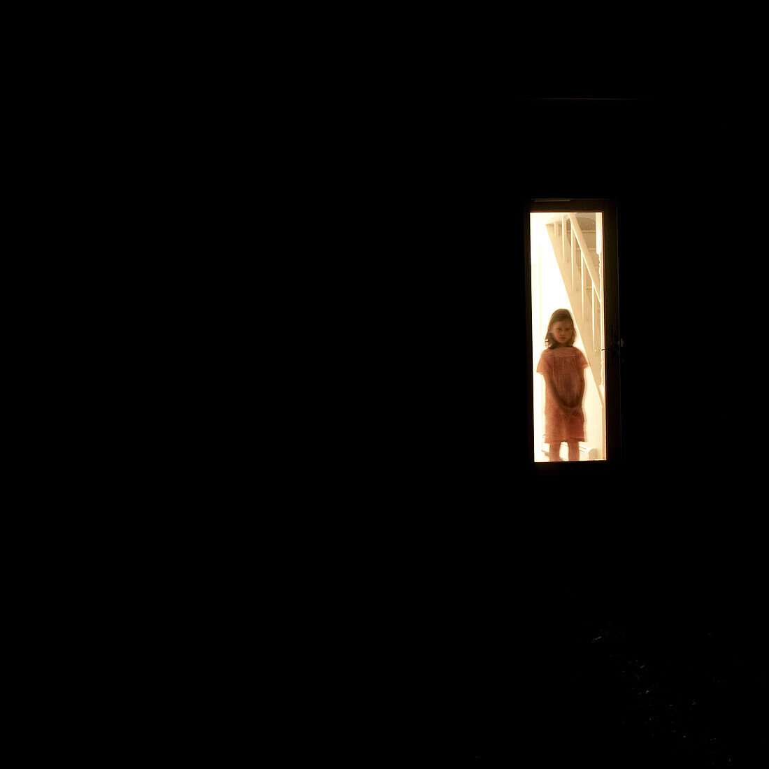 Girl Waiting Behind Screen Door at Night