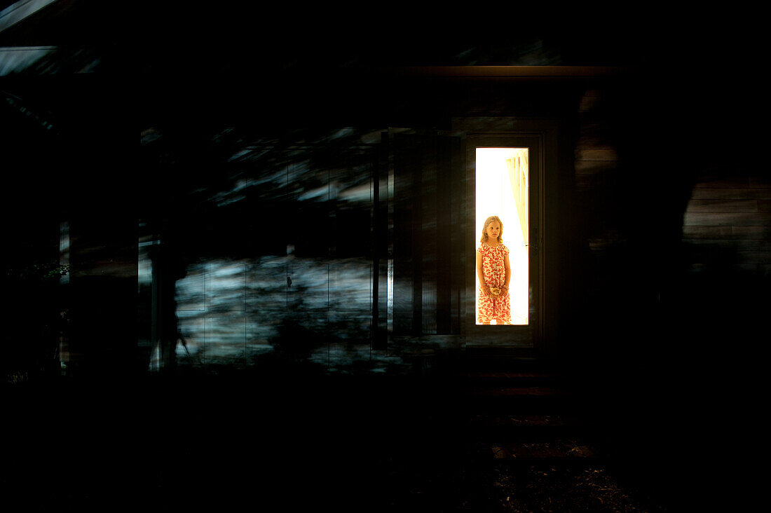 Girl Waiting Behind Screen Door With Shadows at Night