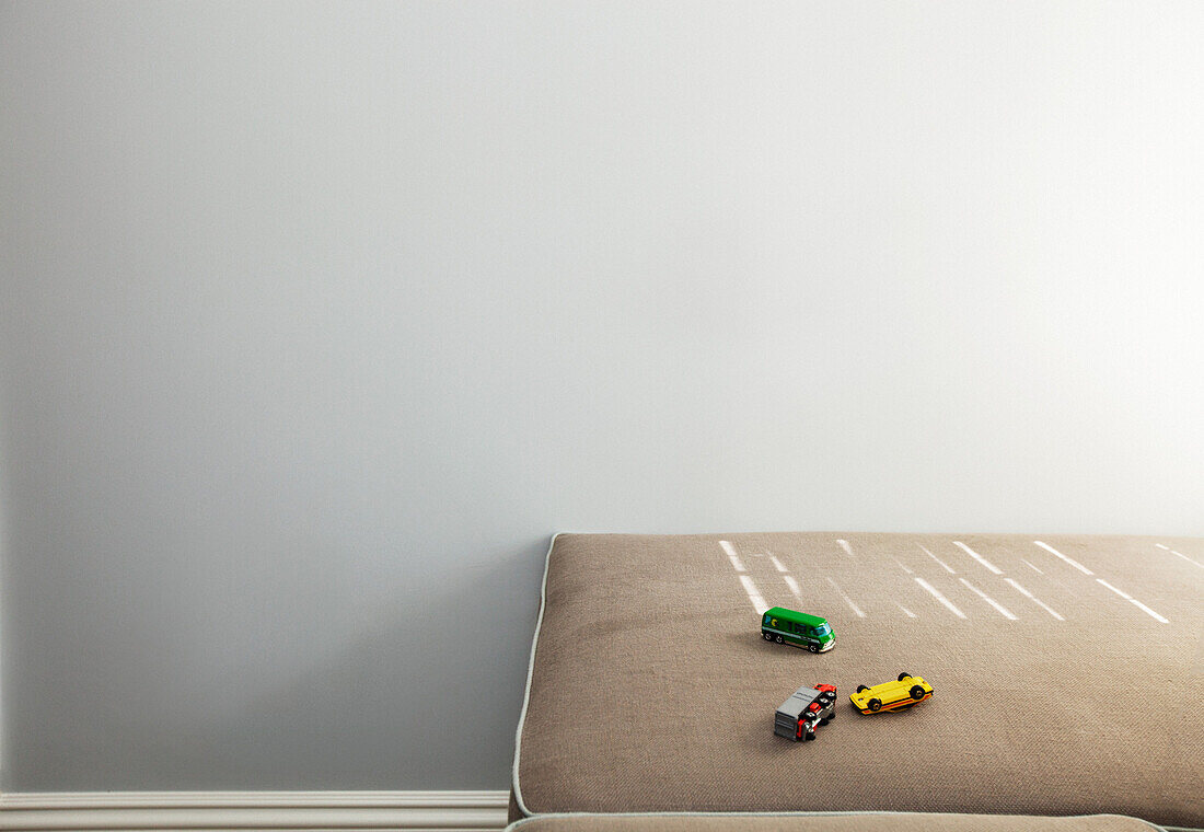 Three Toy Cars on Sofa