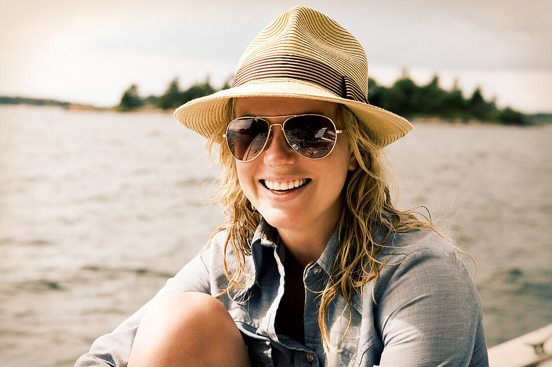 Smiling Woman by Water Wearing Hat and Sunglasses, Portrait, Close Up