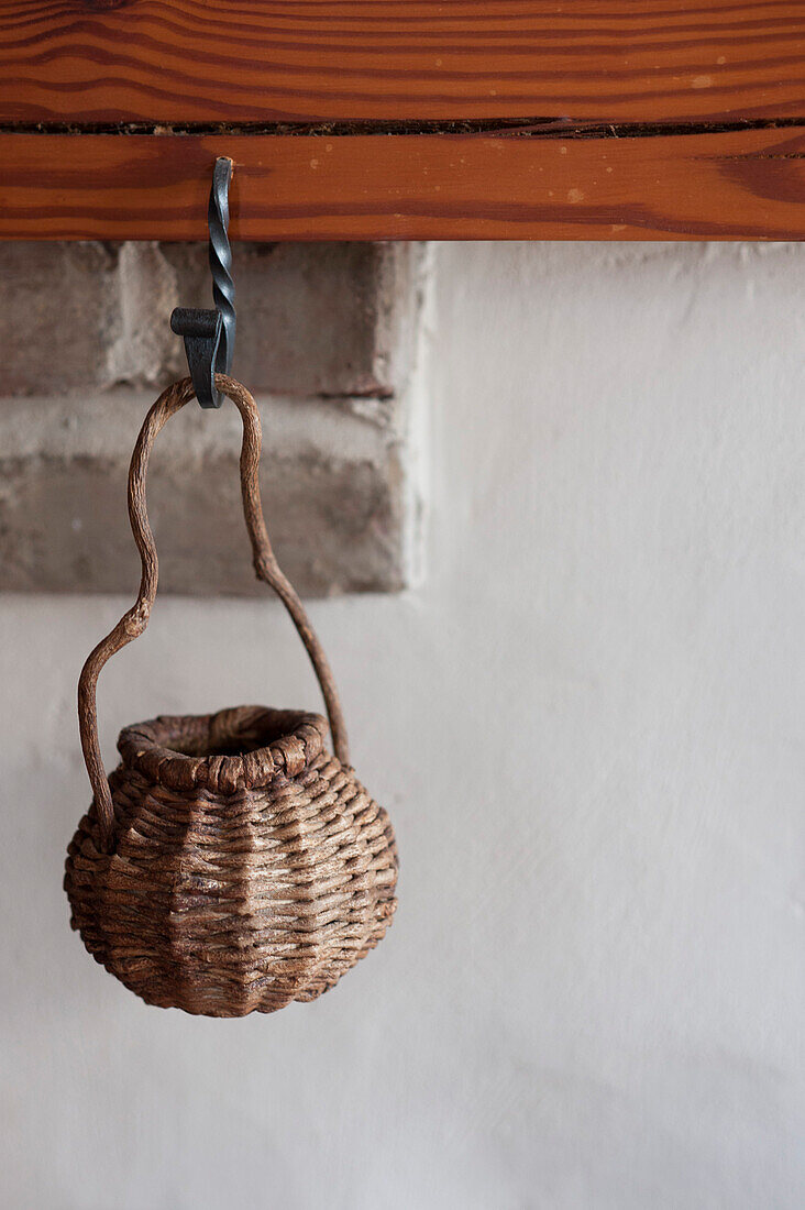 Straw Basket Hanging From Fireplace Mantle
